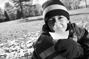 Child with leaf outdoors